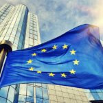 Eu Flag Waving In Front Of European Parliament Building In Bruss