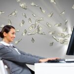 11845239 – young businesswoman in the office with money banknotes around her