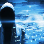 Hacker in a hood on dark blue digital background